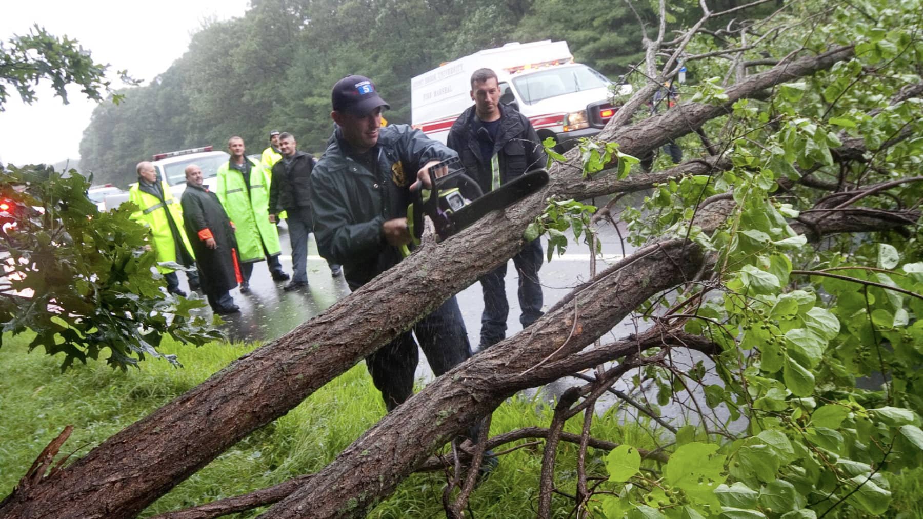 Emergency crew removing fallen trees during Hurricane Sandy.